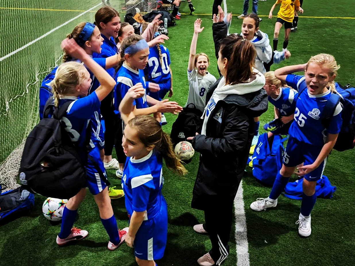 Capital Elite girls soccer team excited after a big win.